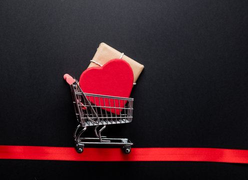 gifts in shopping cart and ribbon
