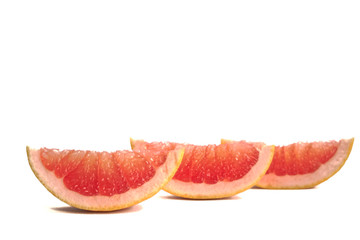 Closeup of grapefruit wedges on a white background