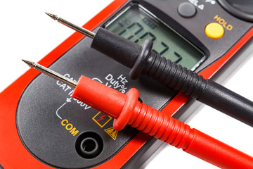 Digital clamp multimeter with probes on a white background