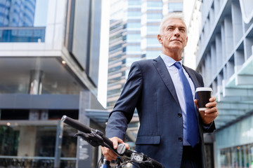 Successful businessman riding bicycle