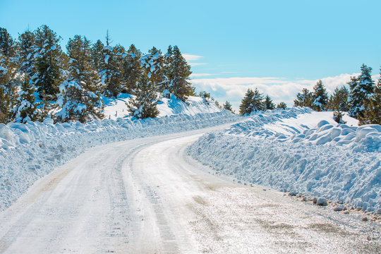 snow-covered small rural road in winter.