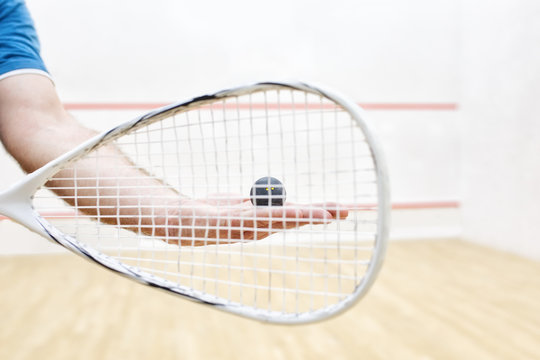 player with squash ball and racket