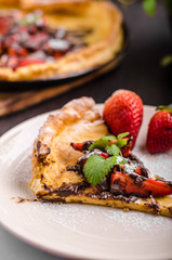 Pancake in oven, dutch baby pancake with strawberries