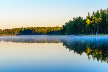 Fototapeta na wymiar Sunrise over the Lake Haukivesi. Over the water mist. Haukivesi lake. Finland.