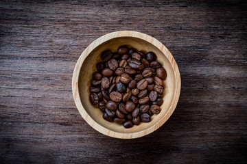coffee beans isolated on wood background.