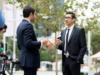 Two businessmen talking outdoors