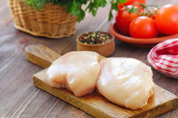 Raw chicken fillet with spices and vegetables