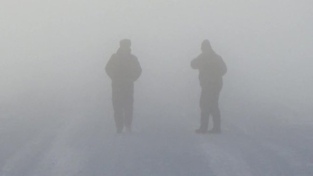 Two people in the fog