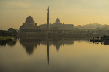 Fototapeta na wymiar PUTRAJAYA, MALAYSIA - 16TH APRIL 2017; Sunrise moment at Putra Mosque, a principal mosque of Putrajaya, Malaysia. Construction of the mosque began in 1997 and was completed two years later.