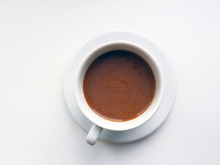 A cup of coffee with tar on a white background