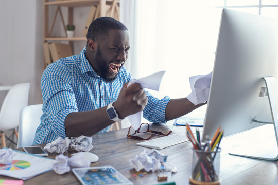 Young african man working in the office business - Powered by Adobe