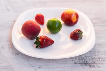 Lime and strawberry on a wooden table
