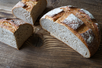 Photo of fresh cut bread on a wooden table
