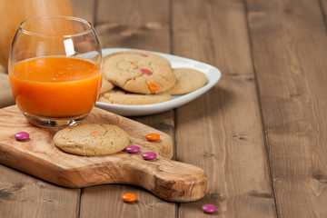Homebaked Chewable Butter Biscuits With Colored Chocolate Sweets. Carrot Juice. Olive Tree Board. Autumn Leaves. Pumpkins.