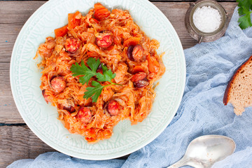 Stewed cabbage with sausages, German cuisine, horizontal, top view