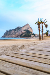 landscape of one of the beaches of Calpe, Alicante, Spain with Penon of Ifach and platform made of wood