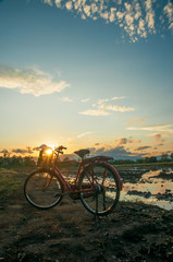 Fototapeta na wymiar Beautiful landscape at sunset time with red classic bicycle