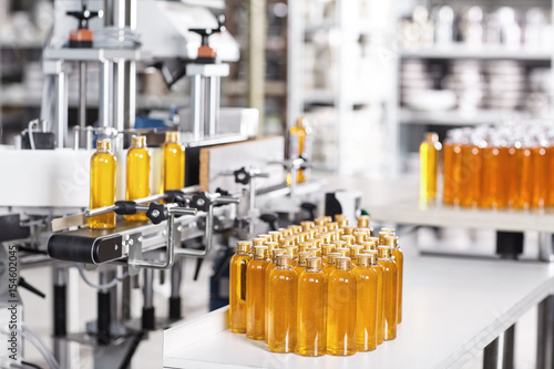 &ldquo;Cosmetics factory. Bottling line filled with yellow shampoo. Automated