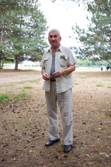 Old man with glasses in park.