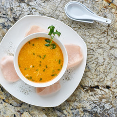 Creamy crab soup served with crab chips and glass of white wine on marble backround. Top view or flat lay.