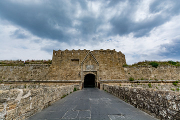 Gate of Saint John, bridge leading to it and moat at Rhodes old town, Greece