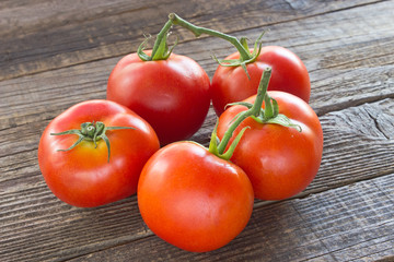 Tomatoes on old wooden background
