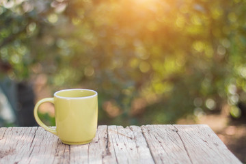 Green coffee cup On the wooden