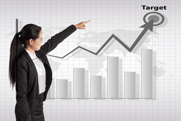 business woman pointing to rising business trends