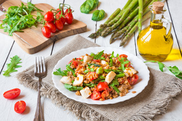 Healthy salad with cereals, asparagus and tomato