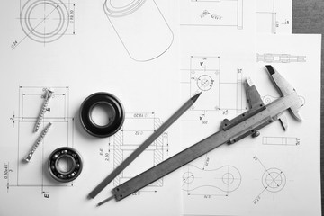 Engineering supplies and blueprints on workplace