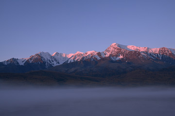Obraz na płótnie Canvas Tops of mountains sparkling by rising sun