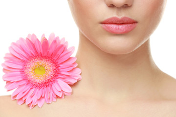 Beautiful young woman with flower on white background, closeup