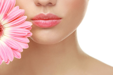 Beautiful young woman with flower on white background, closeup