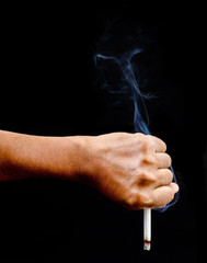 Upside down man hand holding a cigarette with smoke.