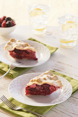 Two Slices of Mixed Berry Pie with Ice Water
