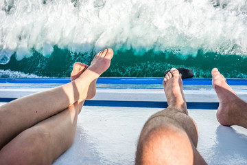 Legs hanging outside Boat