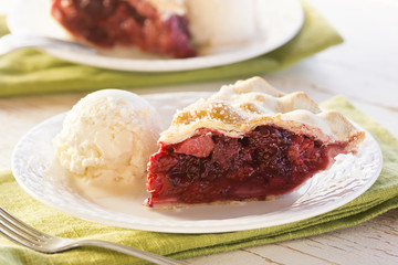 Slice of Mixed Berry Pie with Vanilla Ice Cream