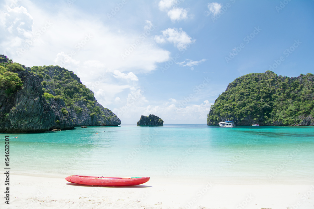 Wall mural looking to red kayaking with beautiful ocean view, white beach and crystal clear water at horseshoe 