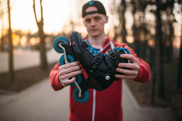 Male person shows roller skates