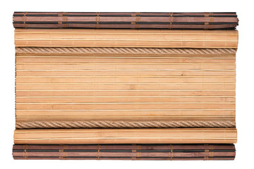 Bamboo mat with curled edges and rope, isolated on white background.