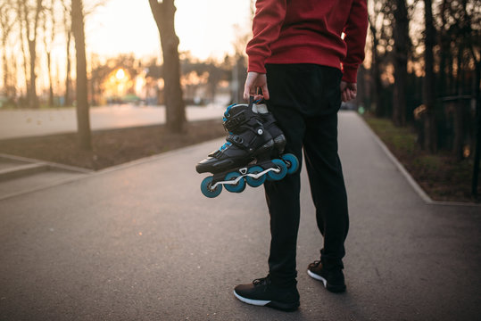Male person hands with roller skates
