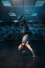 Hip hop motions, male performer in dance studio