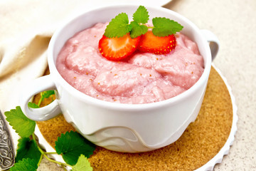 Soup strawberry in bowl with mint on granite table