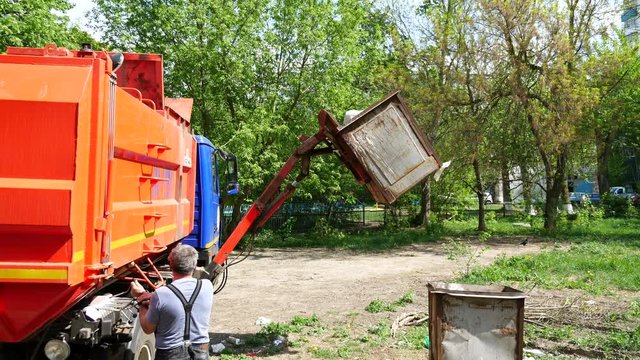 Ecology. Garbage truck loads garbage with the help of a manipulator.