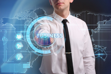 Business, Technology, Internet and network concept. Young businessman working on a virtual screen of the future and sees the inscription: Business