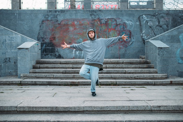 Rap performer posing on the steps, street dancing