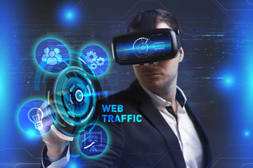 Business, Technology, Internet and network concept. Young businessman working in virtual reality glasses sees the inscription: Web traffic