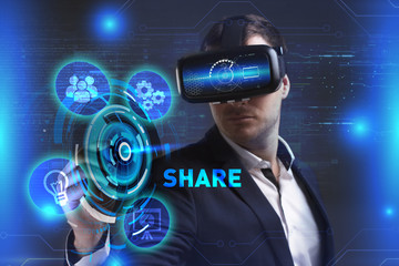 Business, Technology, Internet and network concept. Young businessman working in virtual reality glasses sees the inscription: Share