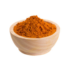 Turmeric powder in wooden bowl on white background
