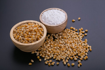 Corn in a wooden bowl on a black background